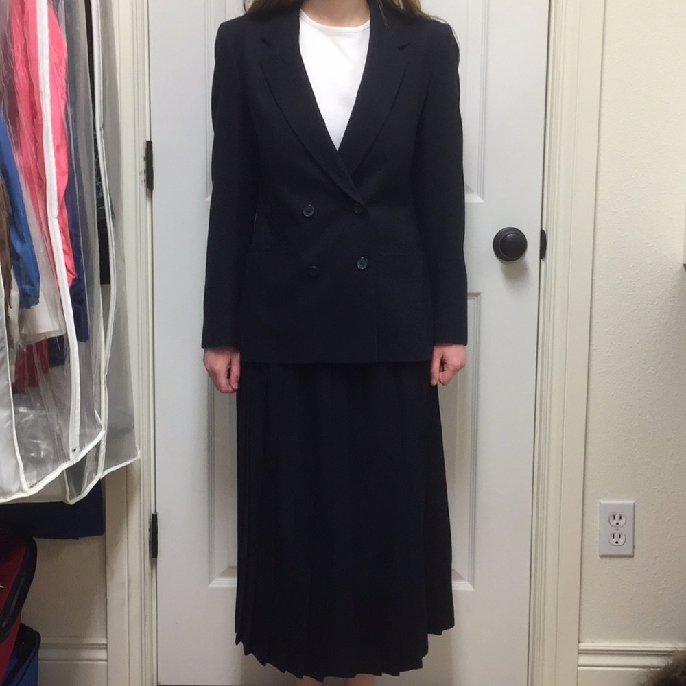 Navy blue suit with pleated skirt